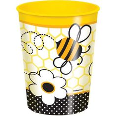 a yellow and black cup with a bee on the front, surrounded by polka dots