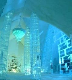 the inside of an ice hotel with lights and snow sculptures on it's walls