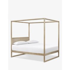 a bed with a metal frame and white sheets