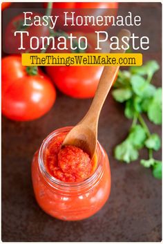 homemade tomato paste in a glass jar with a wooden spoon