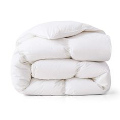 white down comforter stacked on top of each other in front of a white background