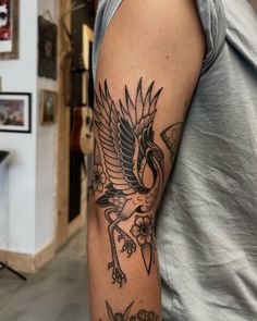 a man with a bird tattoo on his arm