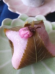 a piece of cake that is sitting on a plate with a flower in the middle