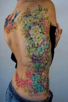 the back of a woman's body with flowers on it