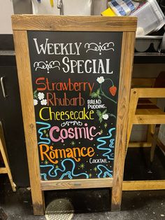 a chalkboard sign with the words weekly special written on it in different languages and colors