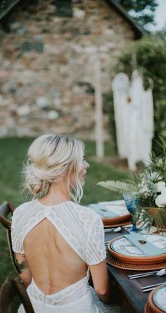 a woman sitting at a table with plates on it