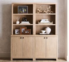 a wooden bookcase filled with lots of books on top of a hard wood floor