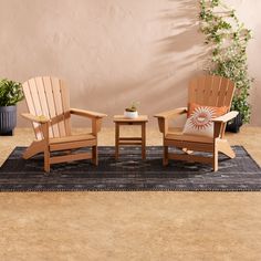 two adiron chairs sitting on top of a rug in front of a wall with potted plants