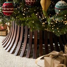 a christmas tree with ornaments on it and presents under the tree in front of it