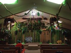 the interior of a church decorated with plants and decorations