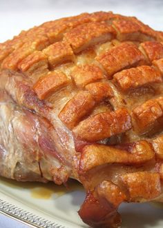 a large piece of meat sitting on top of a white plate