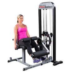 a woman sitting on a bench in front of a gym machine