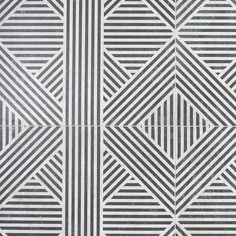 a black and white tiled wall with geometric designs on it's sides, as well as lines in the middle