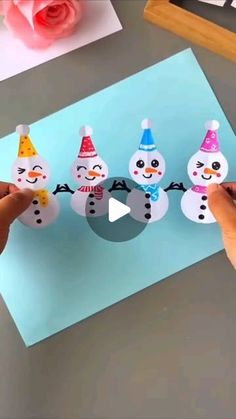 someone is making snowmen out of paper