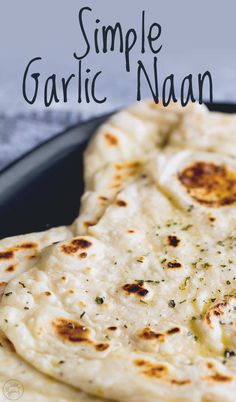 homemade garlic naan on a black plate with text overlay