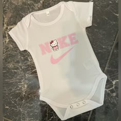 Hello Kitty Nike Onesie Multiple Sizes Available Just Message Me Before Purchasing I Can Do A Matching Set If Wanted If You Want A Different Character Other Then Hello Kitty Just Message Me Same Or Next Day Shipping Sanrio Baby Stuff, Hello Kitty Nike, Babysitting Kit, Nike Onesie