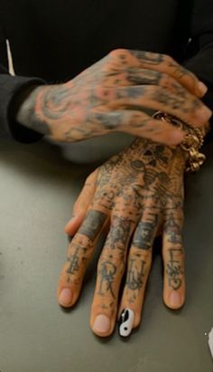 a man with many tattoos on his hands