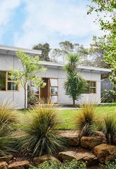 an artist's rendering of a house in the middle of some trees and bushes