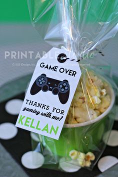 a bowl filled with popcorn sitting on top of a table next to a sign that says game over