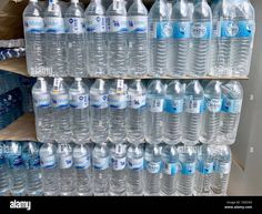 bottled water is stacked on shelves in a store