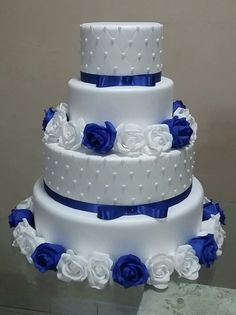 three tiered wedding cake with blue and white flowers