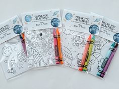 four coloring books with markers in them on a white surface, including thank you blasters