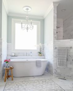 a white bath tub sitting next to a window