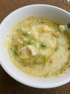 a white bowl filled with soup on top of a table