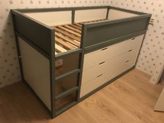 a bunk bed with drawers underneath it in a room that has stars on the wall