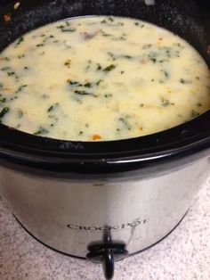 a crock pot filled with broccoli and cheese