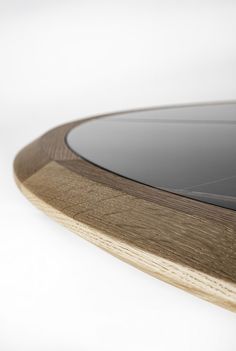 a close up view of a wooden table with glass on the top and bottom edge