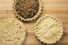 three pies on a wooden table with one cut in half and the other uncooked