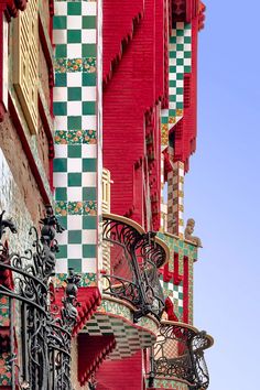 a red building with green and white tiles on it