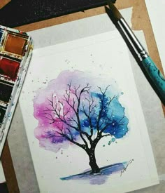 a watercolor painting of a tree with purple and blue colors