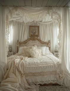 a white bed sitting under a canopy in a bedroom next to a window with curtains