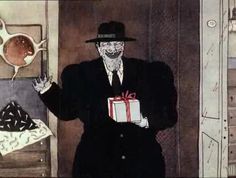 a man in a suit and hat holding a gift