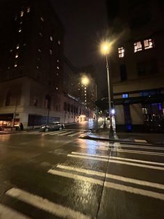 an empty city street at night in the rain