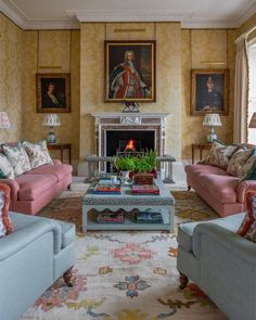 a living room filled with furniture and a fire place in the middle of a room