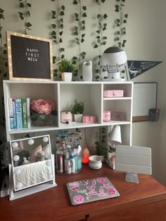 a desk with various items on it in front of a wallpapered planter