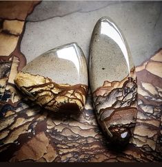 two marbled shoes sitting on top of a floor next to each other with rocks embedded in them