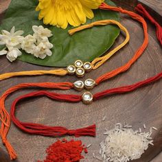 an assortment of beads and flowers on a wooden tray