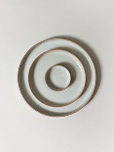 three white plates stacked on top of each other in the shape of an o - ring