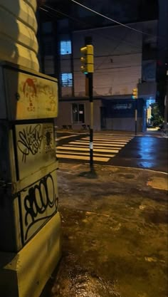 an empty parking lot at night with graffiti on it