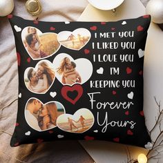 a black pillow with pictures of people and hearts on it, next to christmas decorations