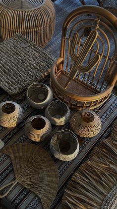 wicker baskets and vases are arranged on a woven tablecloth with rattan accents