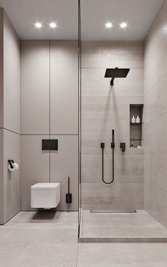 a bathroom with a walk in shower next to a white toilet and wall mounted urinal