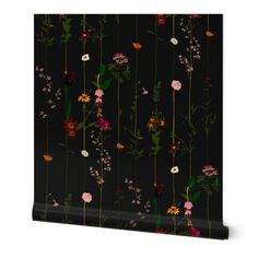 a black wallpaper with colorful flowers on it