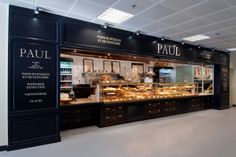 the inside of a bakery with lots of food on display