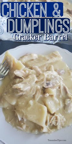 chicken and dumplings in gravy on a white plate with a silver fork