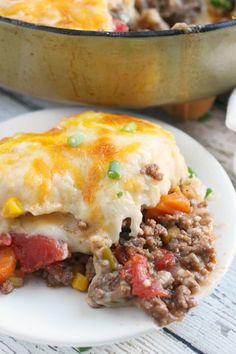 a close up of a plate of food with meat and vegetables on it next to a casserole dish